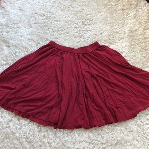 Red flowing pleated skirt.